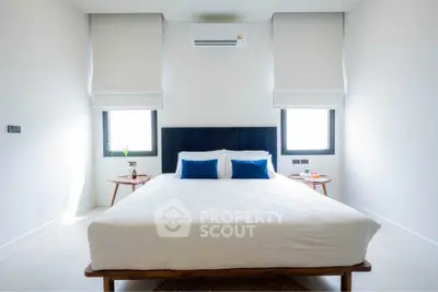 Modern minimalist bedroom with large bed and stylish decor