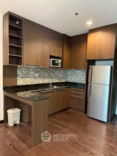 Modern kitchen with sleek wooden cabinets and stainless steel appliances