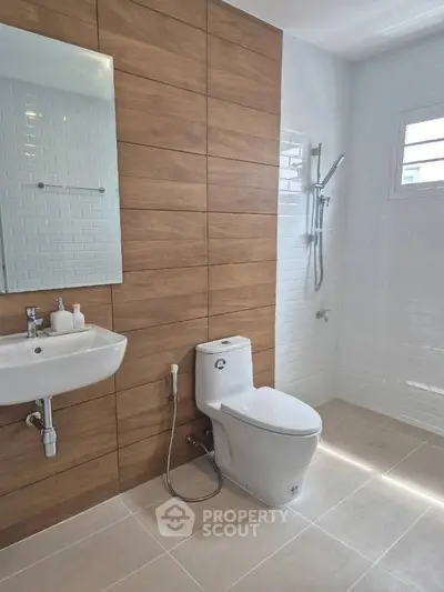 Modern bathroom with wood paneling and sleek fixtures