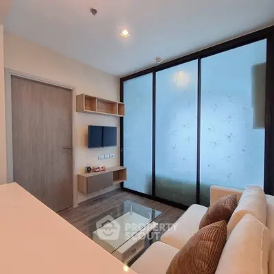 Modern living room with frosted glass wall and cozy seating area