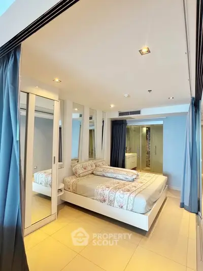 Modern bedroom with mirrored wardrobe and elegant decor