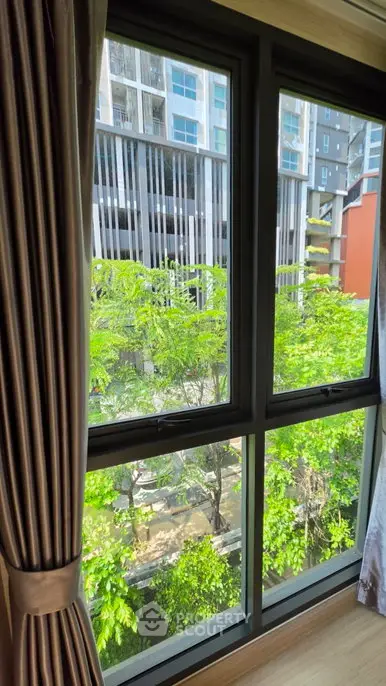 Bright window view with lush greenery and modern building exterior