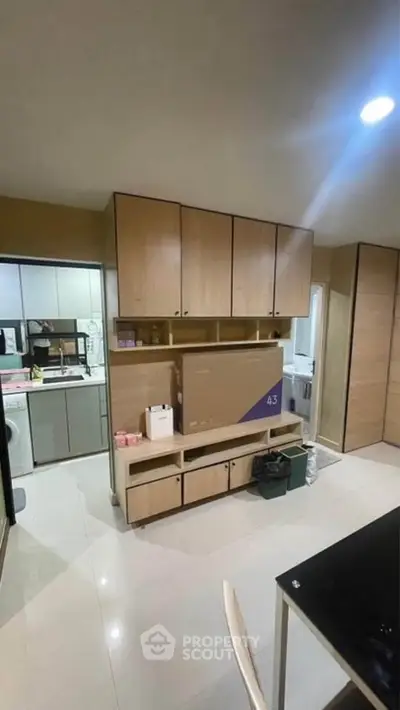 Modern kitchen with ample storage and sleek design, featuring built-in cabinets and appliances.