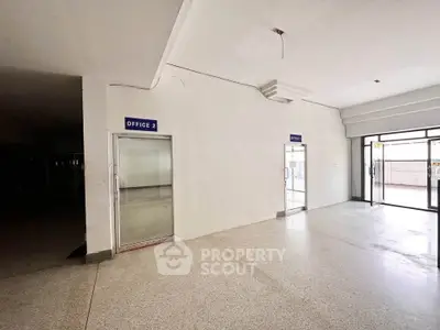 Spacious commercial office space with large windows and ample natural light.