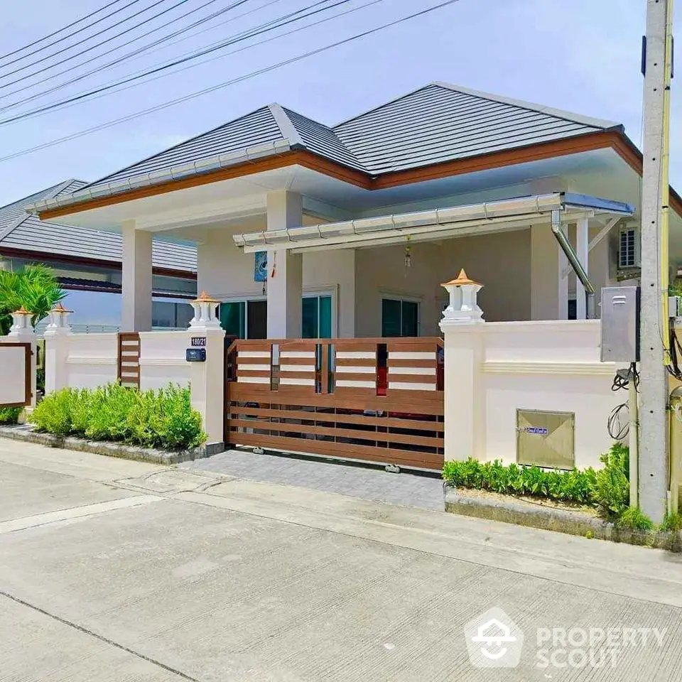 Charming single-story house with modern design and gated entrance in a serene neighborhood.