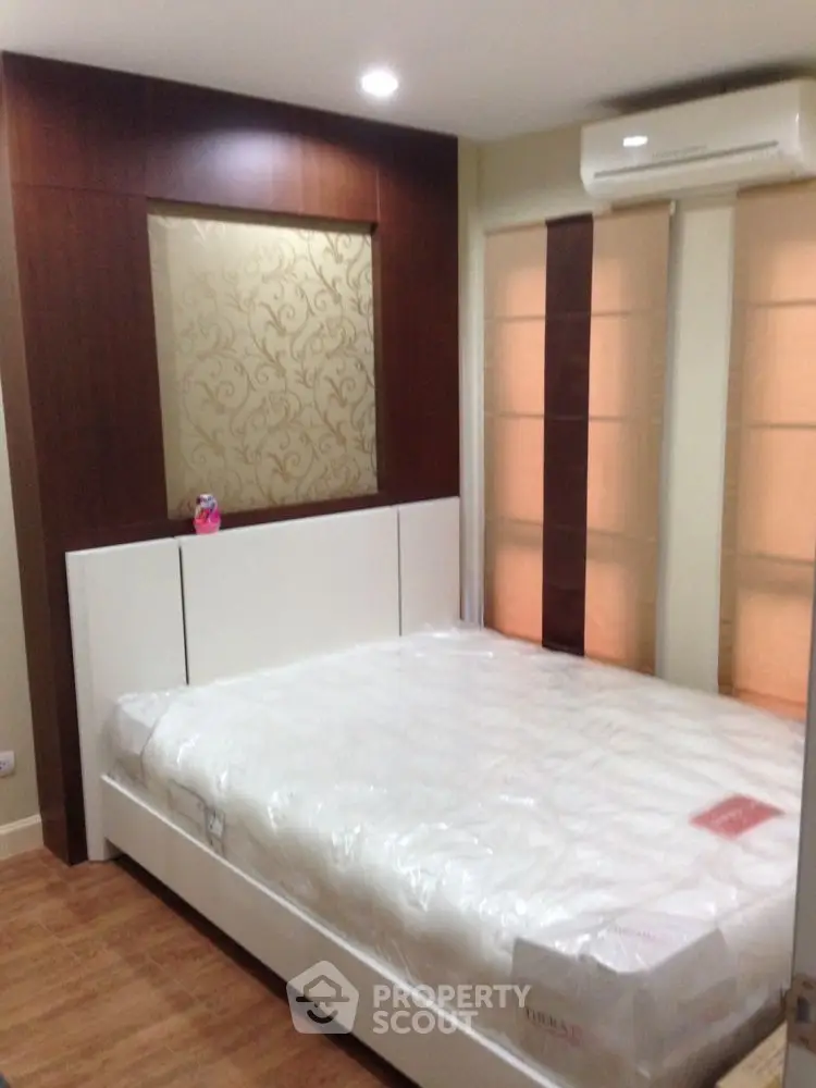Modern bedroom with elegant wood paneling and air conditioning unit