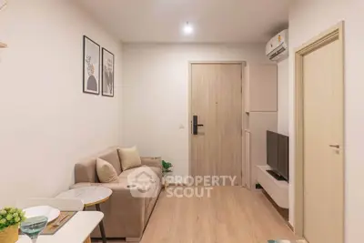 Cozy modern living room with neutral tones and minimalist decor, perfect for relaxation and entertainment.