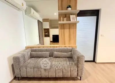 Modern living room with stylish gray sofa and wooden accents, perfect for cozy relaxation.
