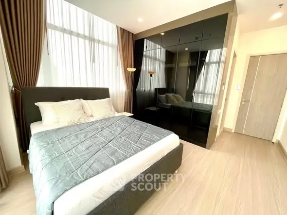 Modern bedroom with floor-to-ceiling windows and sleek black wardrobe
