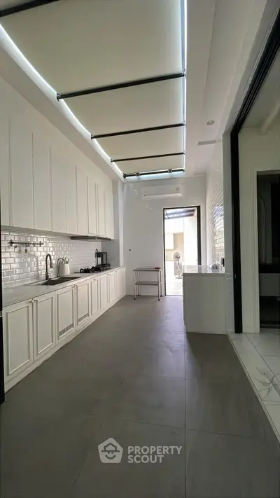 Spacious modern kitchen with sleek cabinetry and open layout, perfect for culinary enthusiasts.