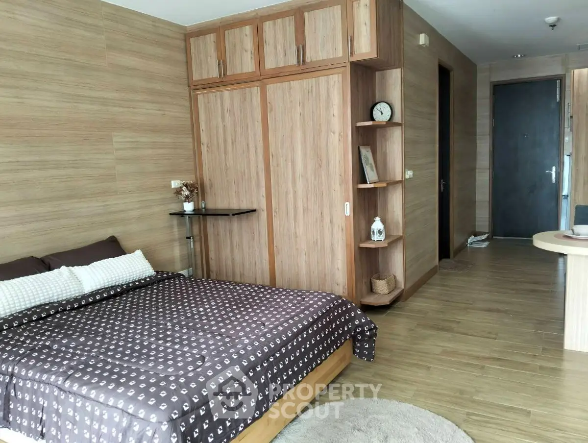 Cozy bedroom with wooden accents and modern decor, featuring a comfortable bed and ample storage space.