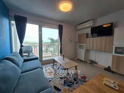 Modern living room with balcony view, featuring stylish furniture and vibrant decor.