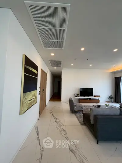 Spacious modern living room with elegant decor and marble flooring