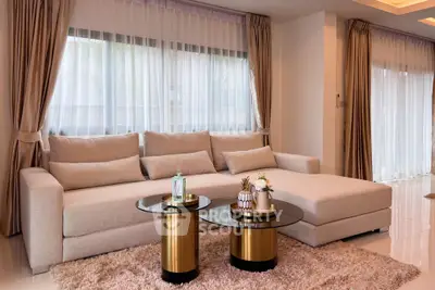 Luxurious living room with elegant beige sofa and chic gold tables