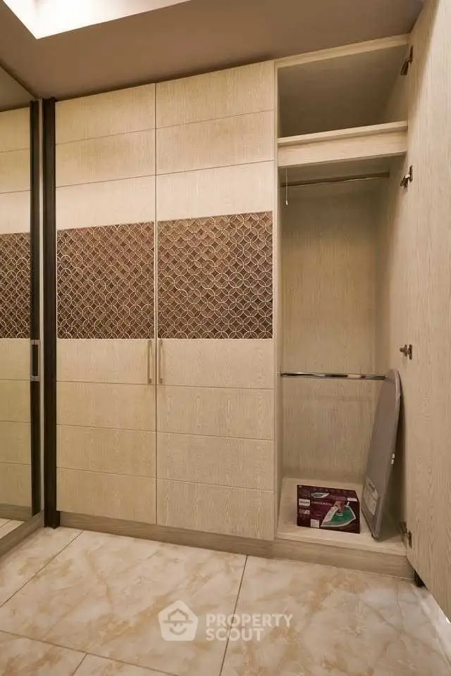 Spacious storage closet with elegant wood finish and tiled floor