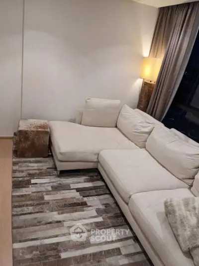 Cozy living room with plush white sectional sofa and ambient lighting