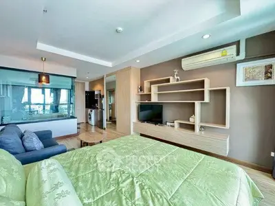 Modern bedroom with stylish shelving and cozy green bedding in a contemporary apartment.