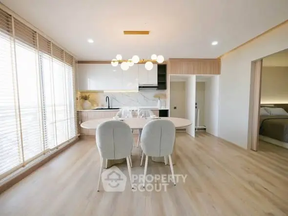 Modern open-plan living room with elegant dining area and natural light