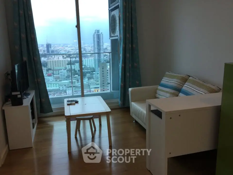 Modern living room with city view, featuring cozy sofa and sleek decor.