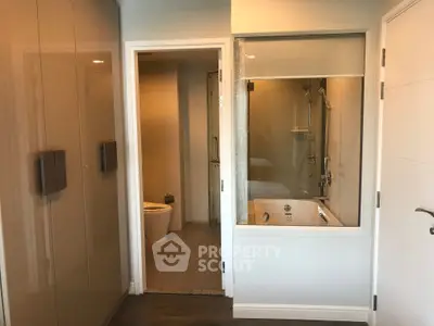 Modern bathroom with glass partition and sleek fixtures