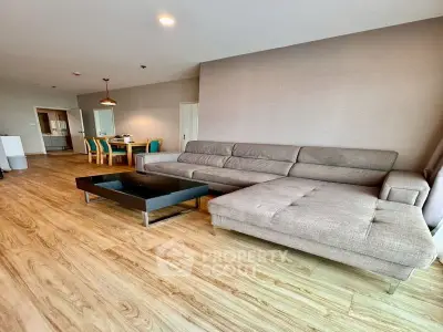 Spacious modern living room with elegant wooden flooring and stylish furniture