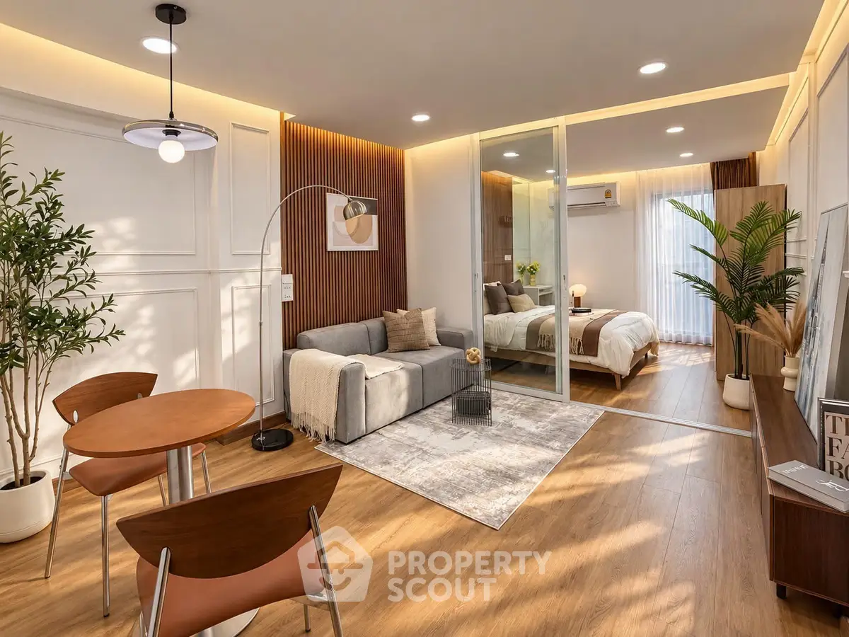 Modern open-plan living room with stylish decor and cozy bedroom view