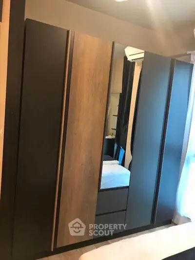 Modern bedroom with sleek wardrobe and cozy ambiance