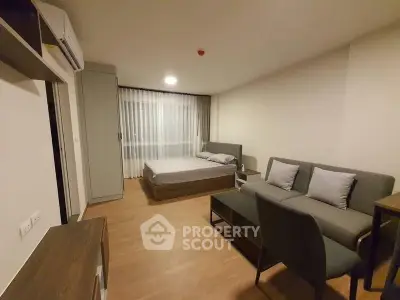 Cozy studio apartment with modern furnishings and wood flooring