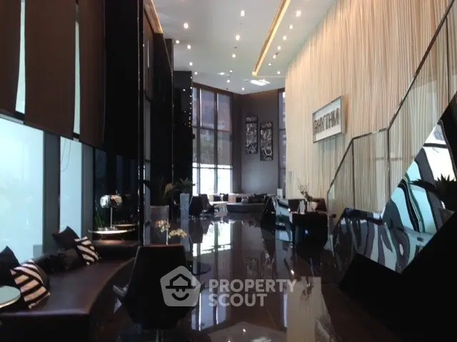 Luxurious modern lobby with sleek design and high ceilings in upscale building.