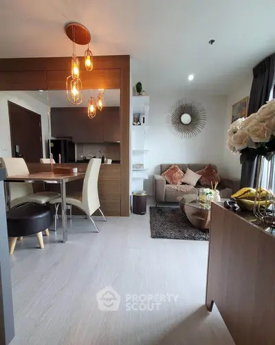 Modern living room with stylish decor and open layout, featuring elegant lighting and cozy seating area.