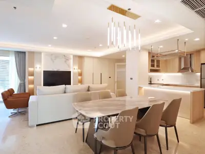 Luxurious open-plan living and dining area with modern furnishings and elegant lighting in a high-end apartment.