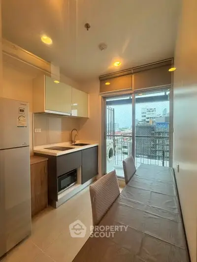 Modern kitchen with balcony view in urban apartment