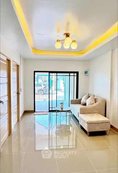 Bright and modern living room with elegant lighting and cozy seating area.