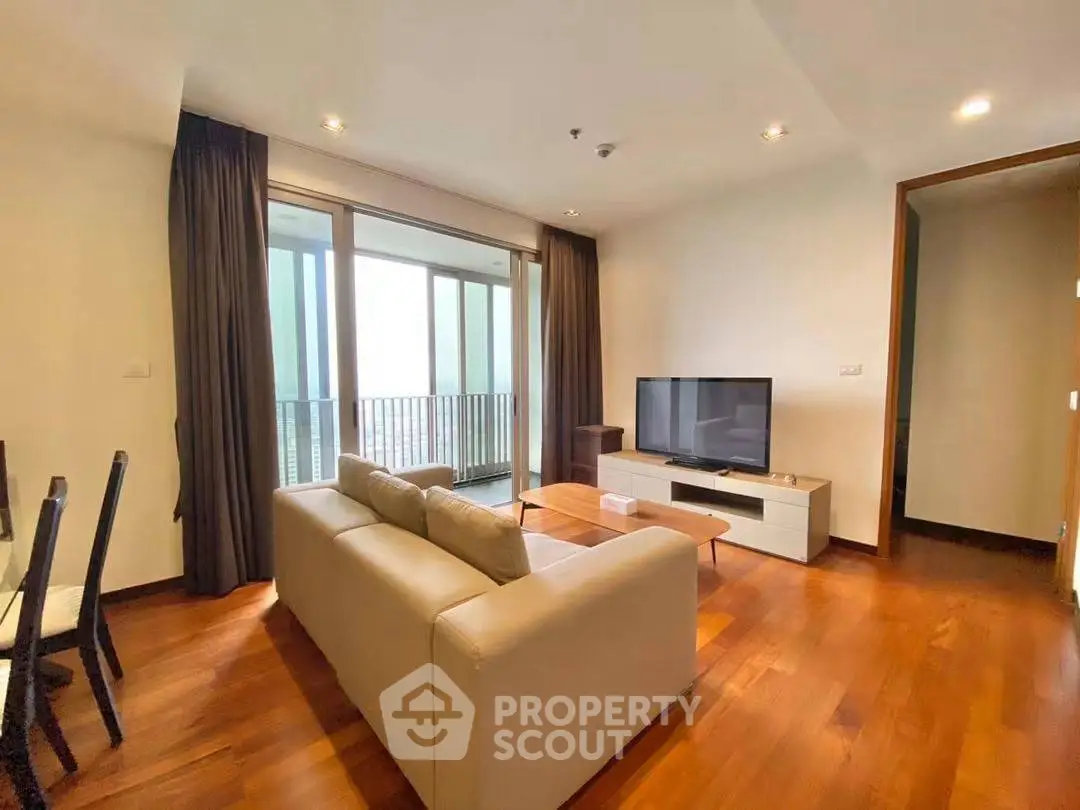 Spacious living room with modern decor and balcony access in a luxury apartment.