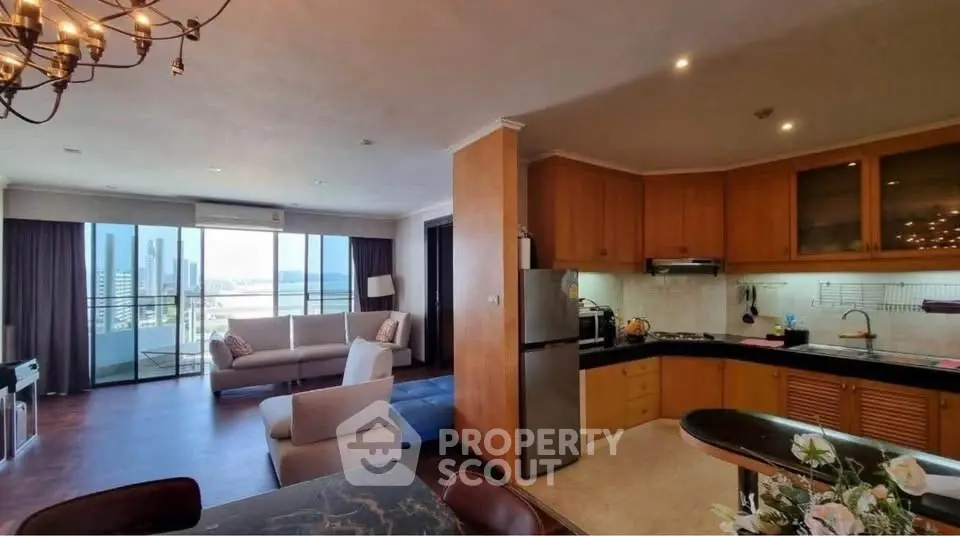 Spacious open-plan living room and kitchen with city view balcony.