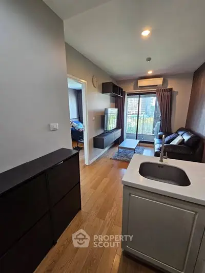 Modern apartment with open layout, cozy living room, and city view balcony.