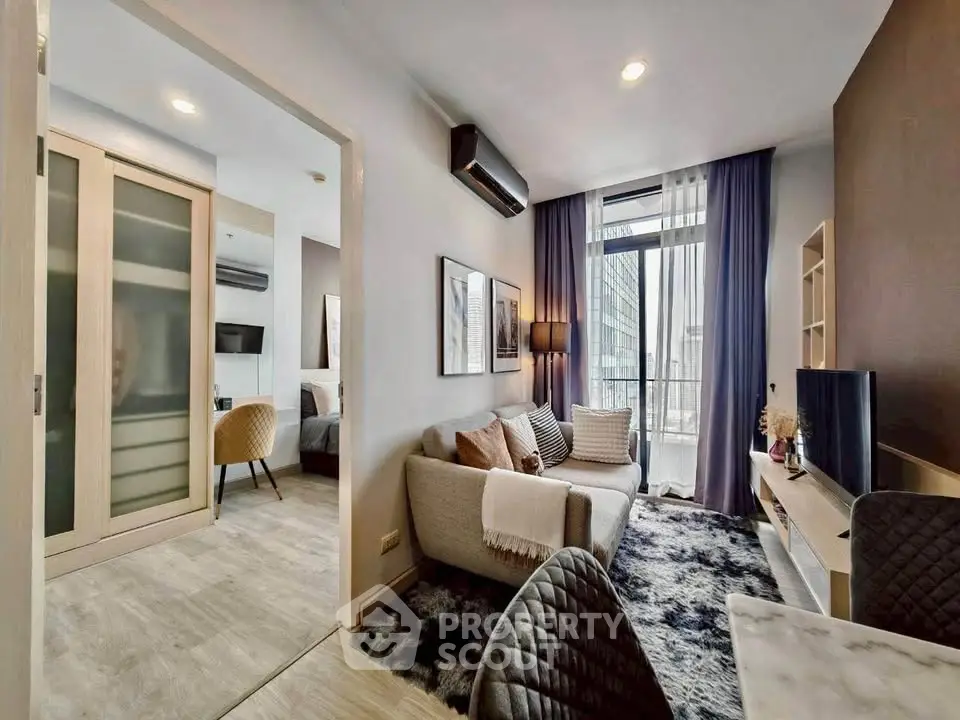 Modern living room with cozy decor and city view, featuring stylish furniture and open layout.