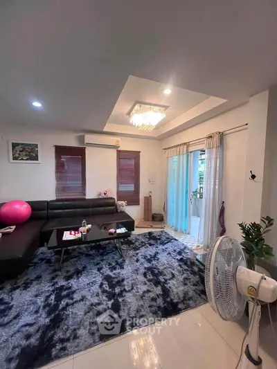 Spacious living room with modern decor and large windows for natural light.