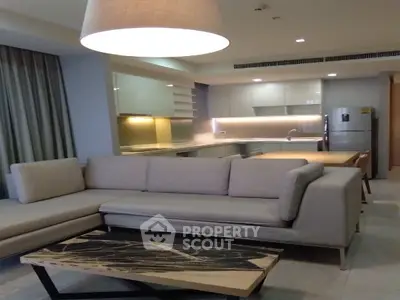 Modern living room with open kitchen layout and stylish furniture