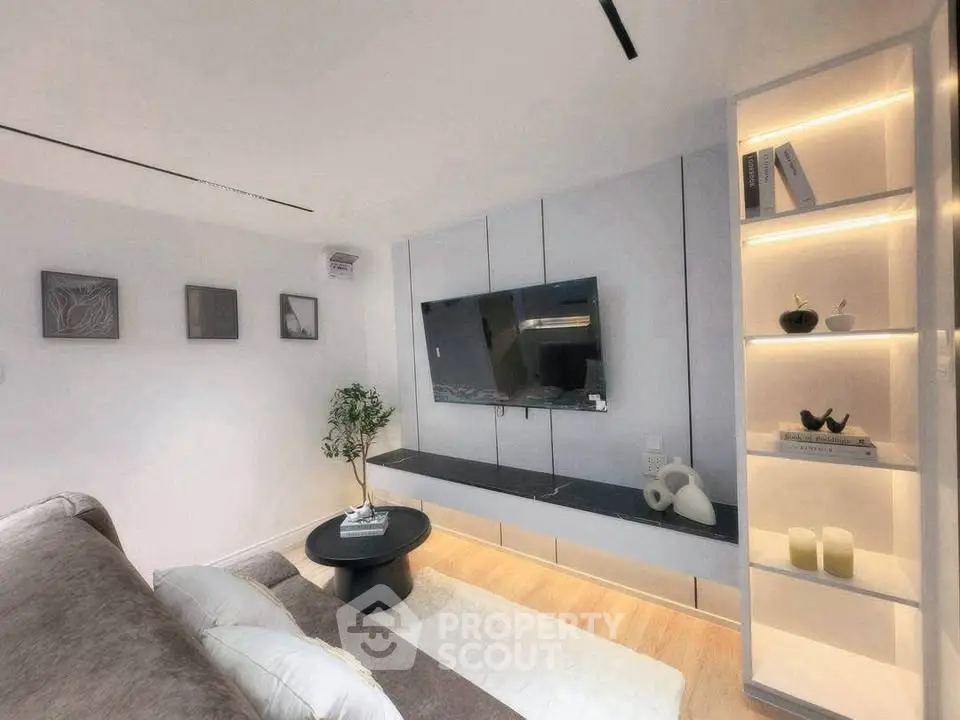 Modern living room with sleek TV setup and stylish shelving