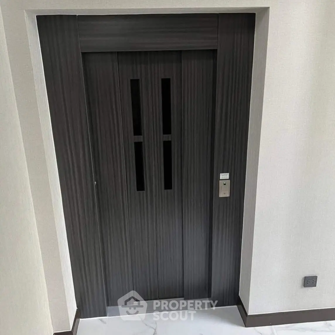 Modern elevator door in a stylish residential building lobby