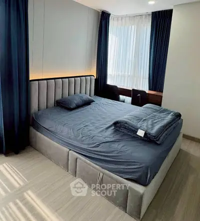 Spacious bedroom with modern design and large windows for natural light.