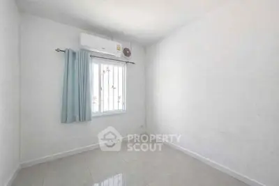 Minimalist empty room with air conditioning and tiled floor, ready for customization.