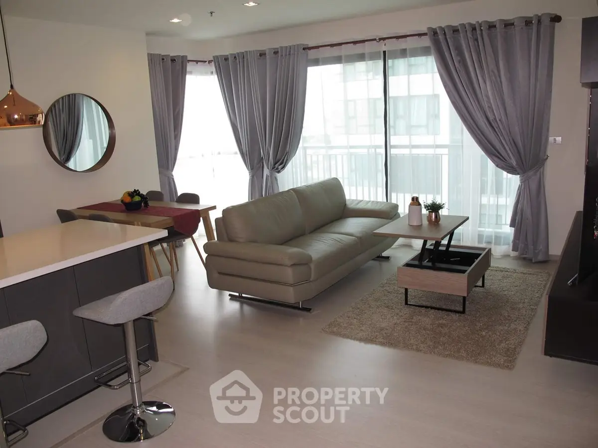 Modern living room with sleek furniture and large windows in a stylish apartment.