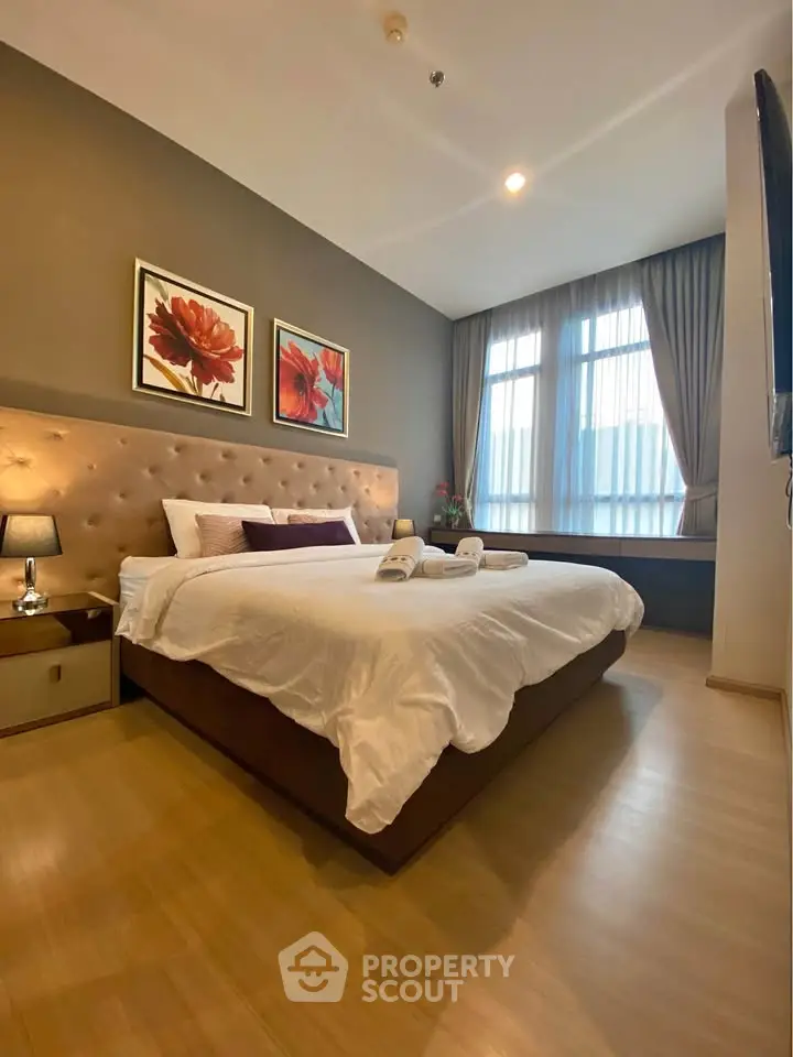 Luxurious bedroom with elegant decor and large window for natural light