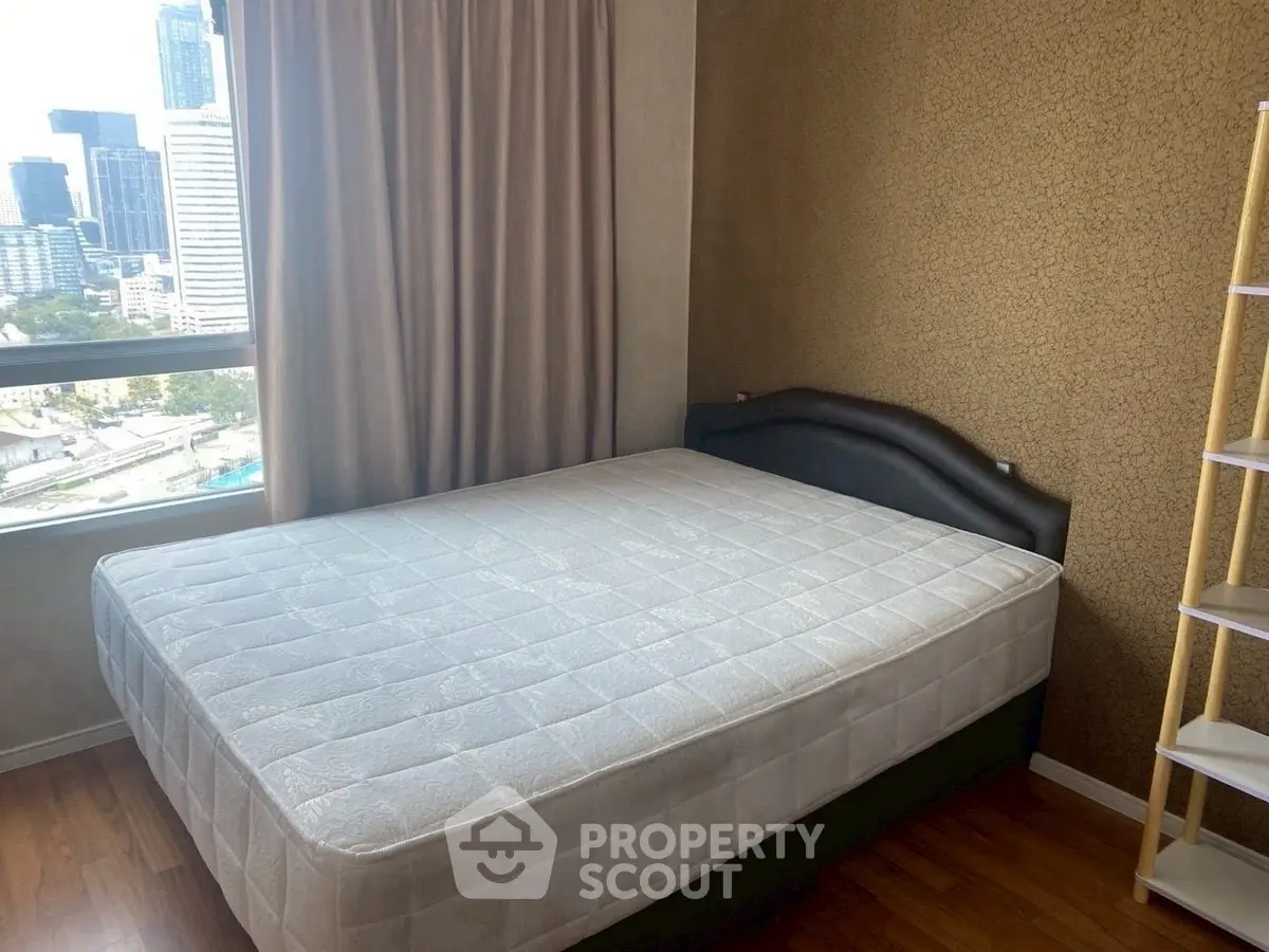 Spacious bedroom with city view and modern decor in urban apartment