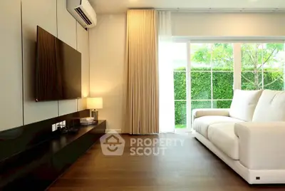 Modern living room with large window and stylish furniture