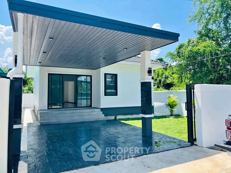 Modern single-story house with sleek carport and lush green lawn