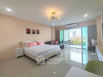 Spacious modern bedroom with city view and balcony access