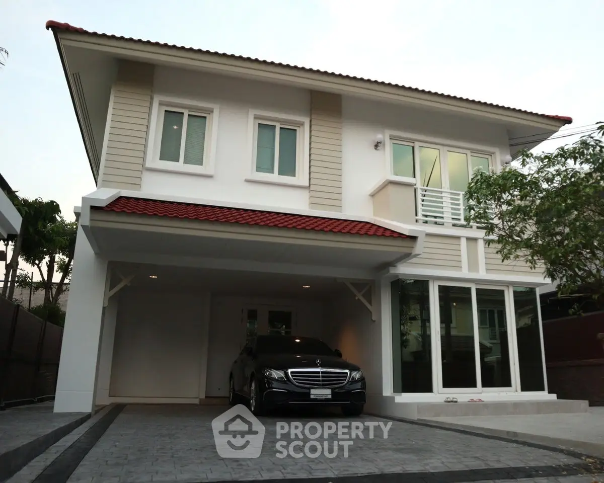 Modern two-story house with carport and sleek design